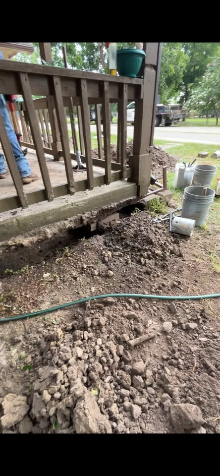 Foundation repair work along a porch