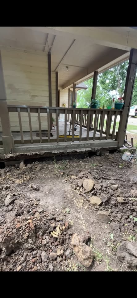 Foundation work beneath a porch